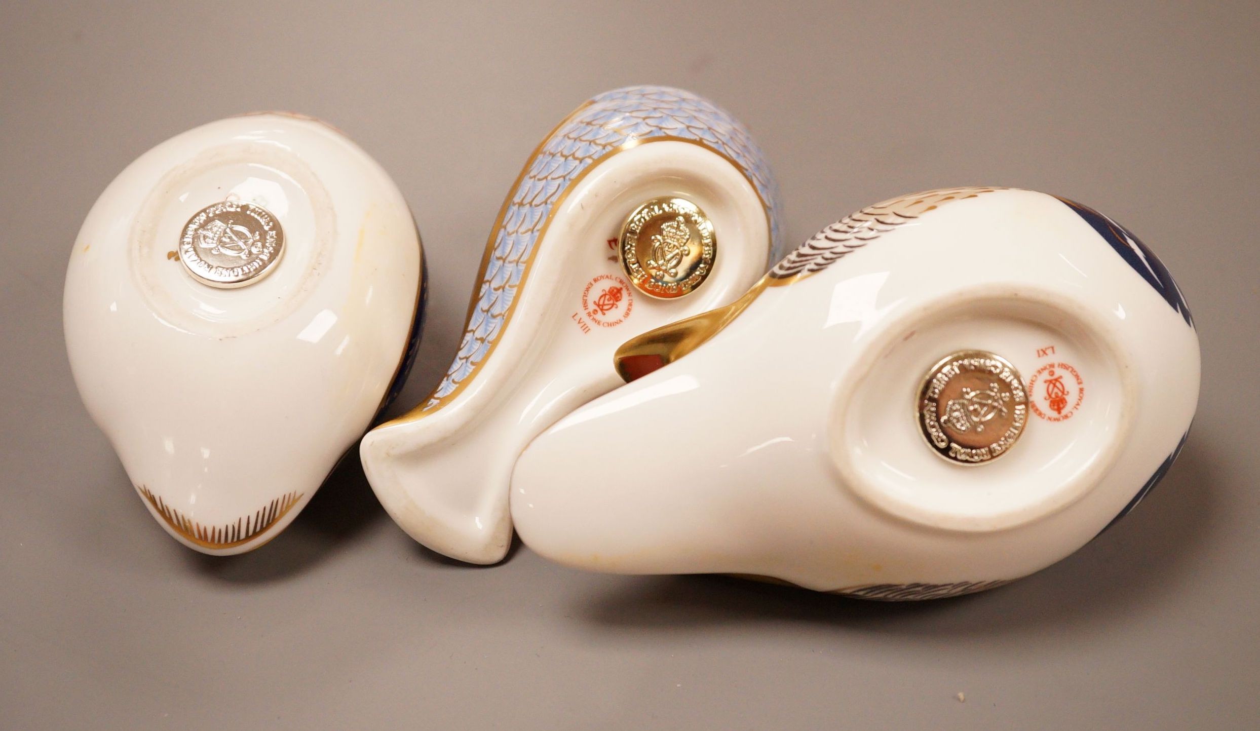 Three Royal Crown Derby Imari paperweights; a duck and two birds, silver badge